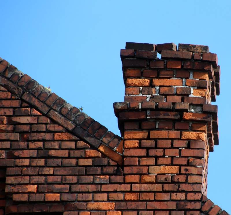 Signs Your Harwood Heights Home Needs a Chimney Inspection Damaged chimney on an Harwood Heights home showing cracks and missing mortar